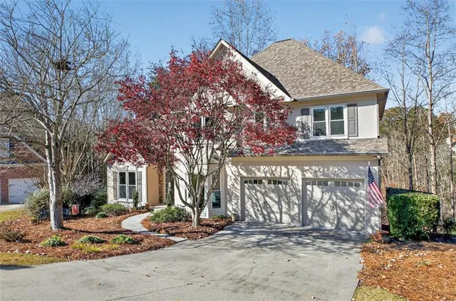 a front view of a house with parking area