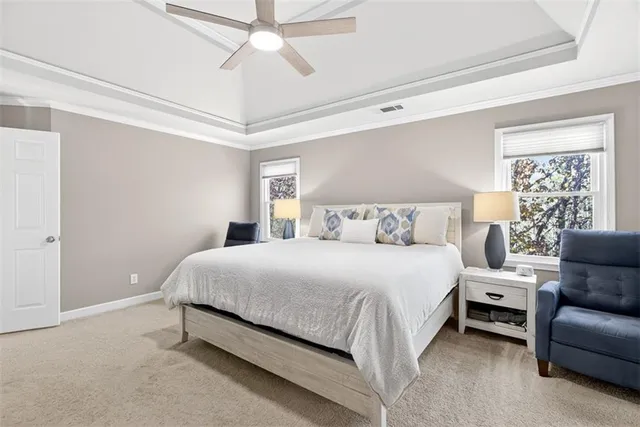 a bedroom with a bed and a flat tv screen on dresser