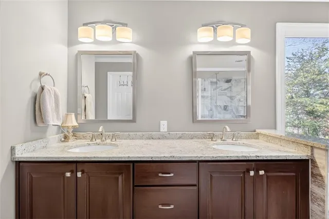 a spacious bathroom with a granite countertop tub sink and mirror