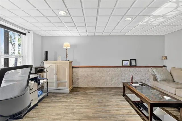 a view of a bedroom with a furniture and wooden floor