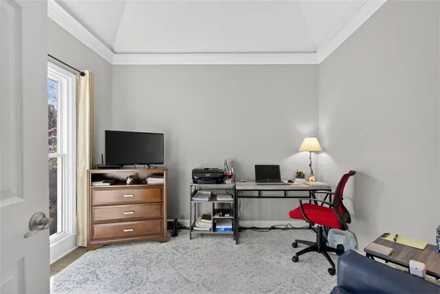 a view of a workspace with furniture and a window