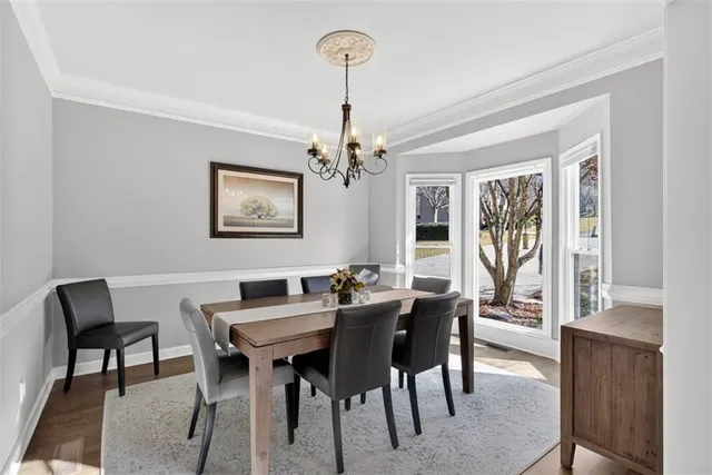a view of a dining room with furniture and chandelier