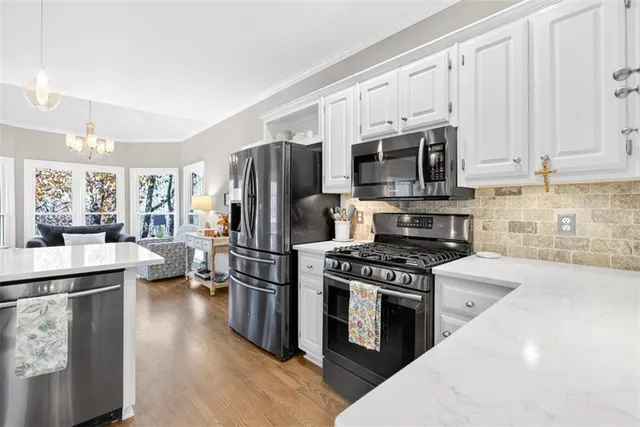 a kitchen with stainless steel appliances a stove microwave and a refrigerator