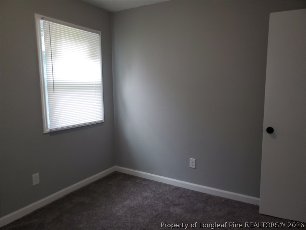 724 Spruce Street Lumberton, NC 28358 - Photo 12 of 13 an empty room with a window