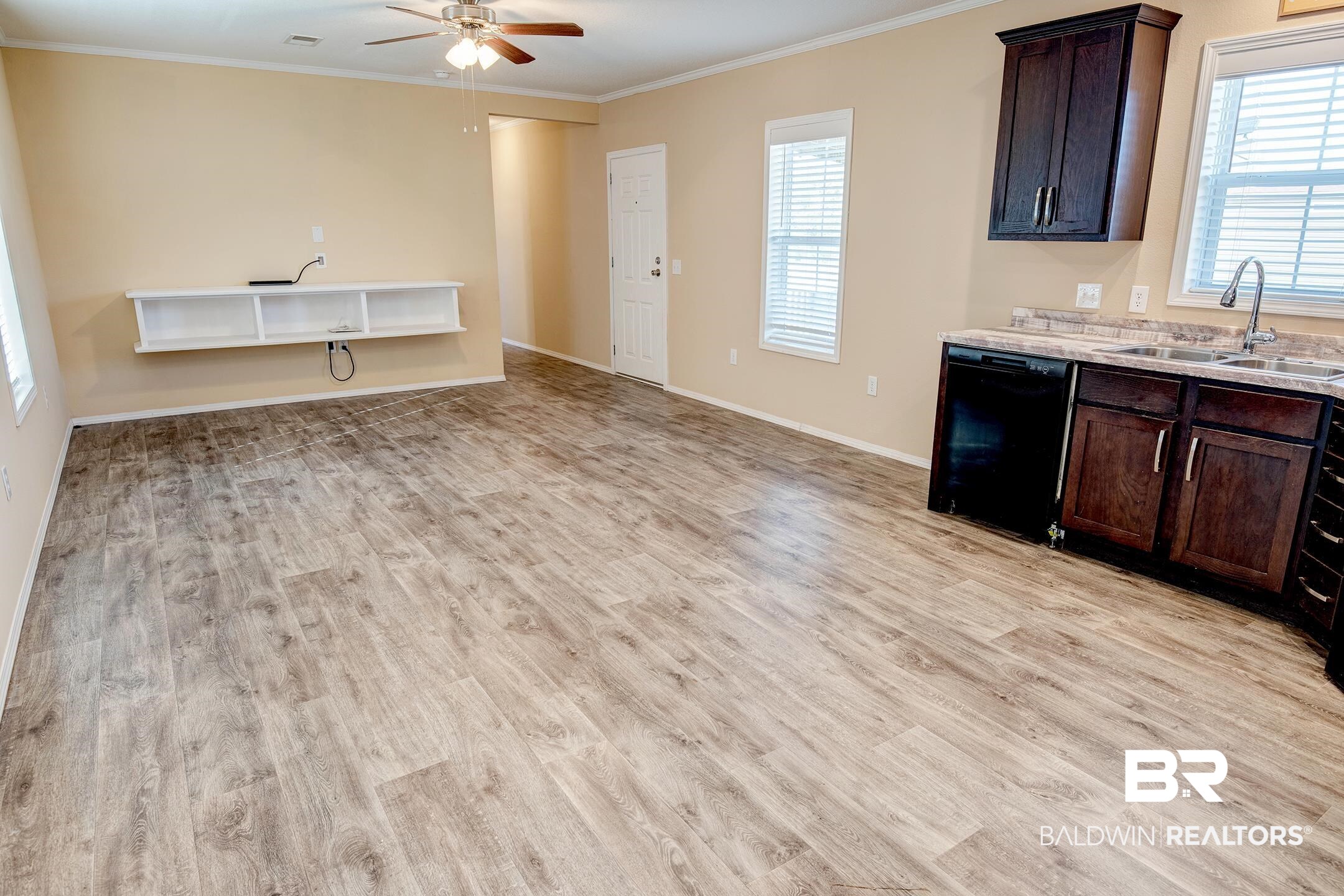 21859 West Side Loop Silverhill, AL 36576 - Photo 17 of 24 Kitchen with sink, dark brown cabinets, black dishwasher, and light hardwood / wood-style flooring