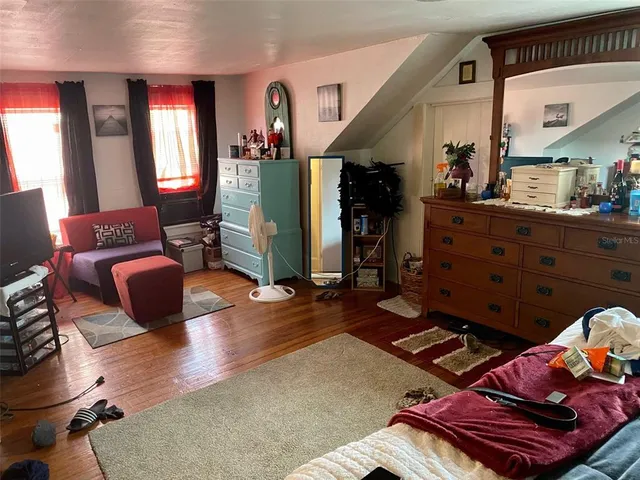 a bedroom with bed and a window