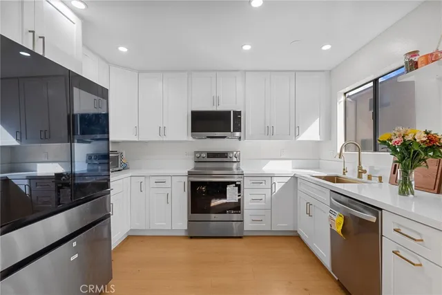 a kitchen with a sink stove and microwave