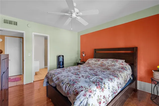 a bedroom with a bed and wooden floor