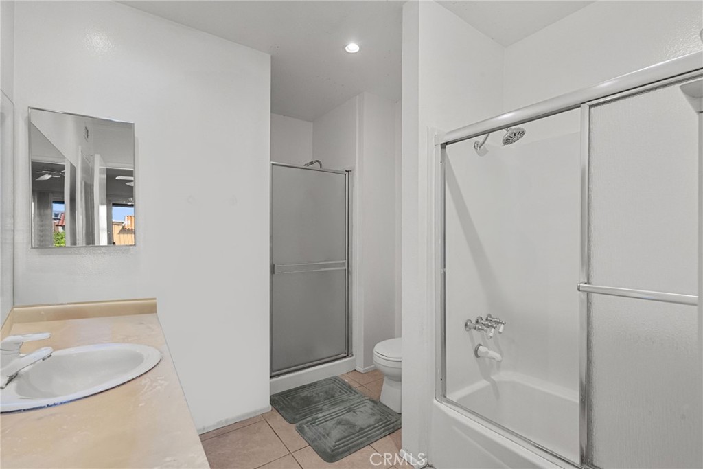 19545 Sherman Way, Unit 74 Reseda, CA 91335 - Photo 20 of 26 a bathroom with a granite countertop sink toilet and shower