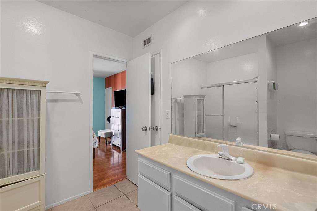 19545 Sherman Way, Unit 74 Reseda, CA 91335 - Photo 21 of 26 a bathroom with a granite countertop sink and a mirror