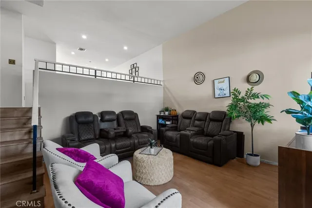 a living room with furniture a window and wooden floor