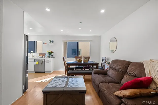 a living room with furniture and kitchen view
