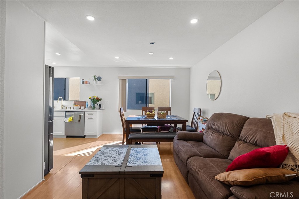 19545 Sherman Way, Unit 74 Reseda, CA 91335 - Photo 9 of 26 a living room with furniture and kitchen view