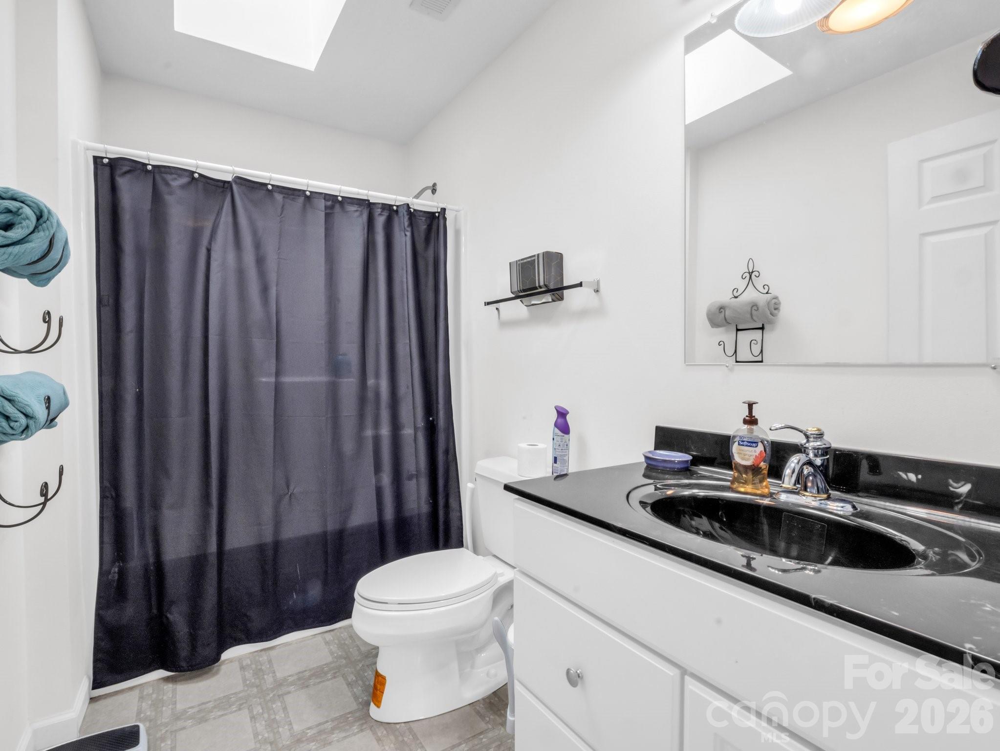 532 Harvey Logan Road Bostic, NC 28018 - Photo 39 of 48 a bathroom with a sink a toilet and shower curtain