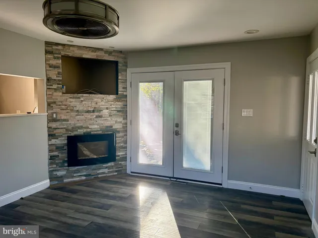 a living room with a fireplace and a flat screen tv