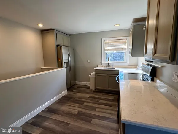 a kitchen with a refrigerator and a sink