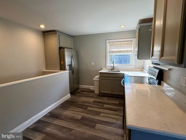 a kitchen with a refrigerator and a sink