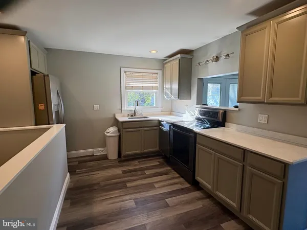 a kitchen with a sink stove and refrigerator