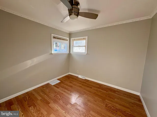 a view of an empty room with wooden floor