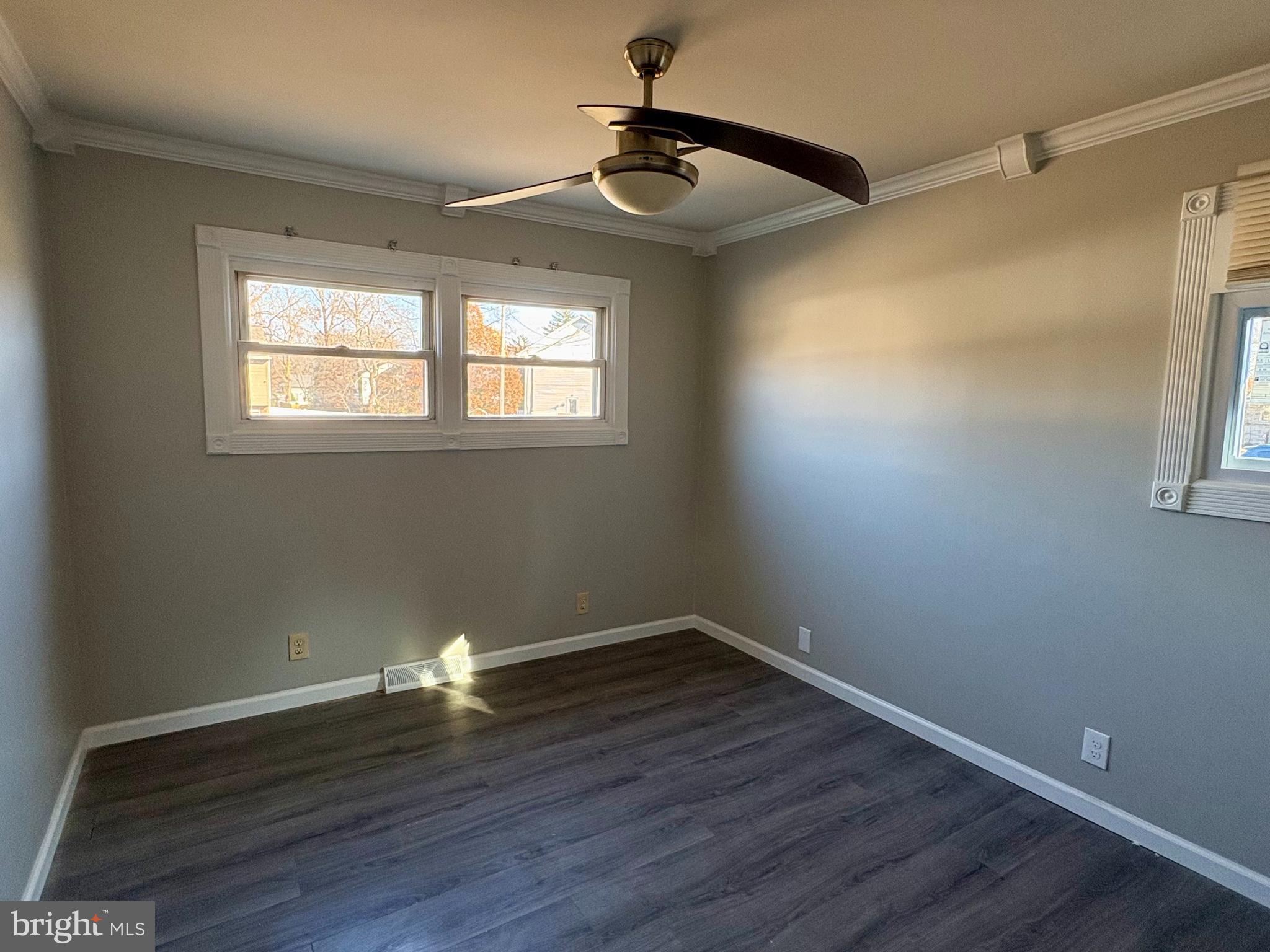 1401 Filbert Street Glassboro, NJ 08028 - Photo 8 of 9 a empty room with wooden floor and windows
