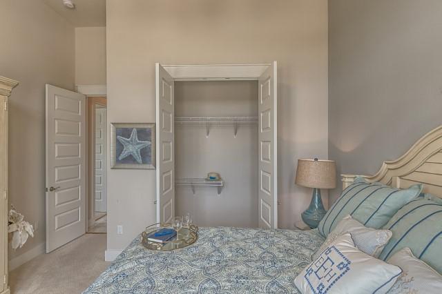 54 Pine Lands Loop Ln Inlet Beach West, Unit B Inlet Beach, FL 32461 - Photo 33 of 35 a bedroom with a bed and a table