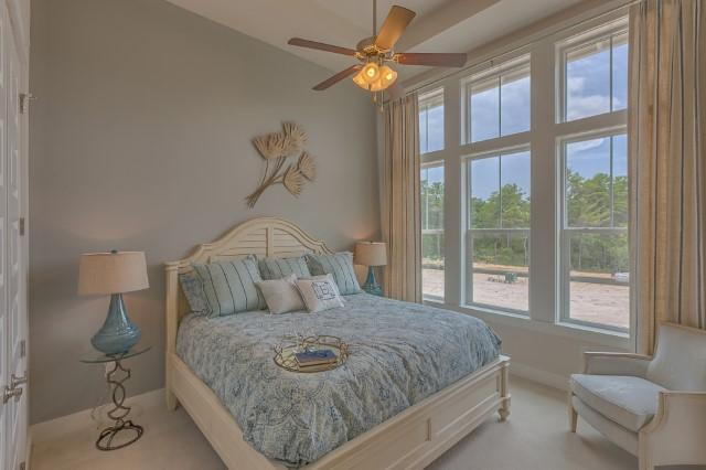 54 Pine Lands Loop Ln Inlet Beach West, Unit B Inlet Beach, FL 32461 - Photo 34 of 35 a bedroom with a bed chandelier and a window