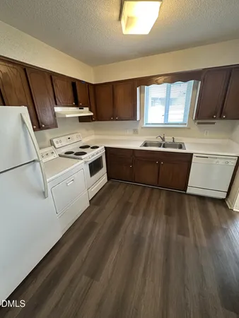 a kitchen with stainless steel appliances granite countertop a stove a sink dishwasher and a refrigerator