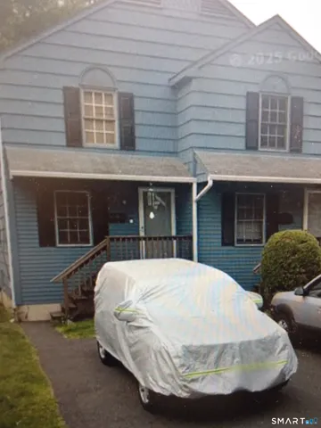 a view of a house with a yard and sitting area