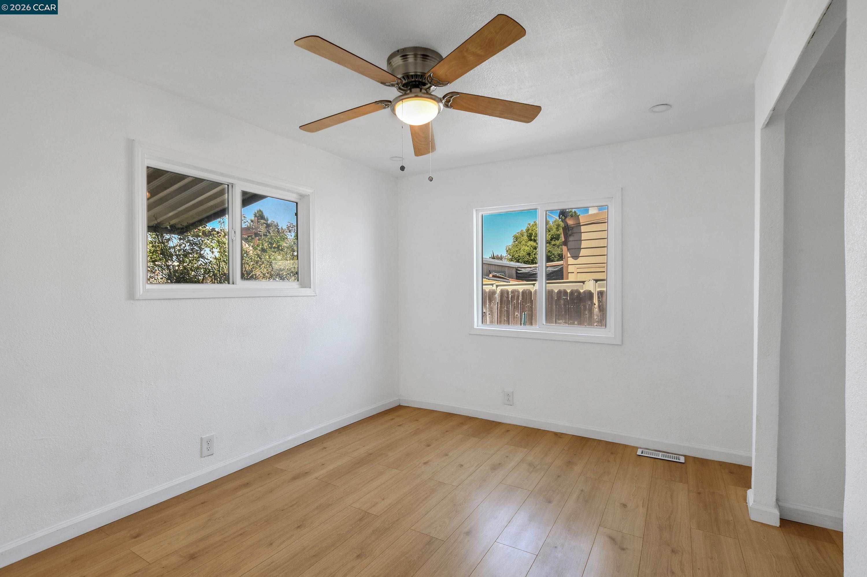 237 Orangevale Pittsburg, CA 94565 - Photo 15 of 21 a view of empty room with wooden floor and fan