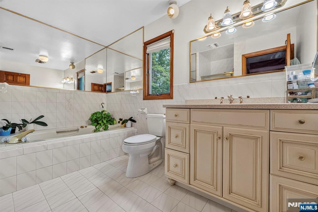 5110 Berkshire Valley Road Oak Ridge, NJ 07438 - Photo 25 of 49 a bathroom with a granite countertop sink mirror and toilet
