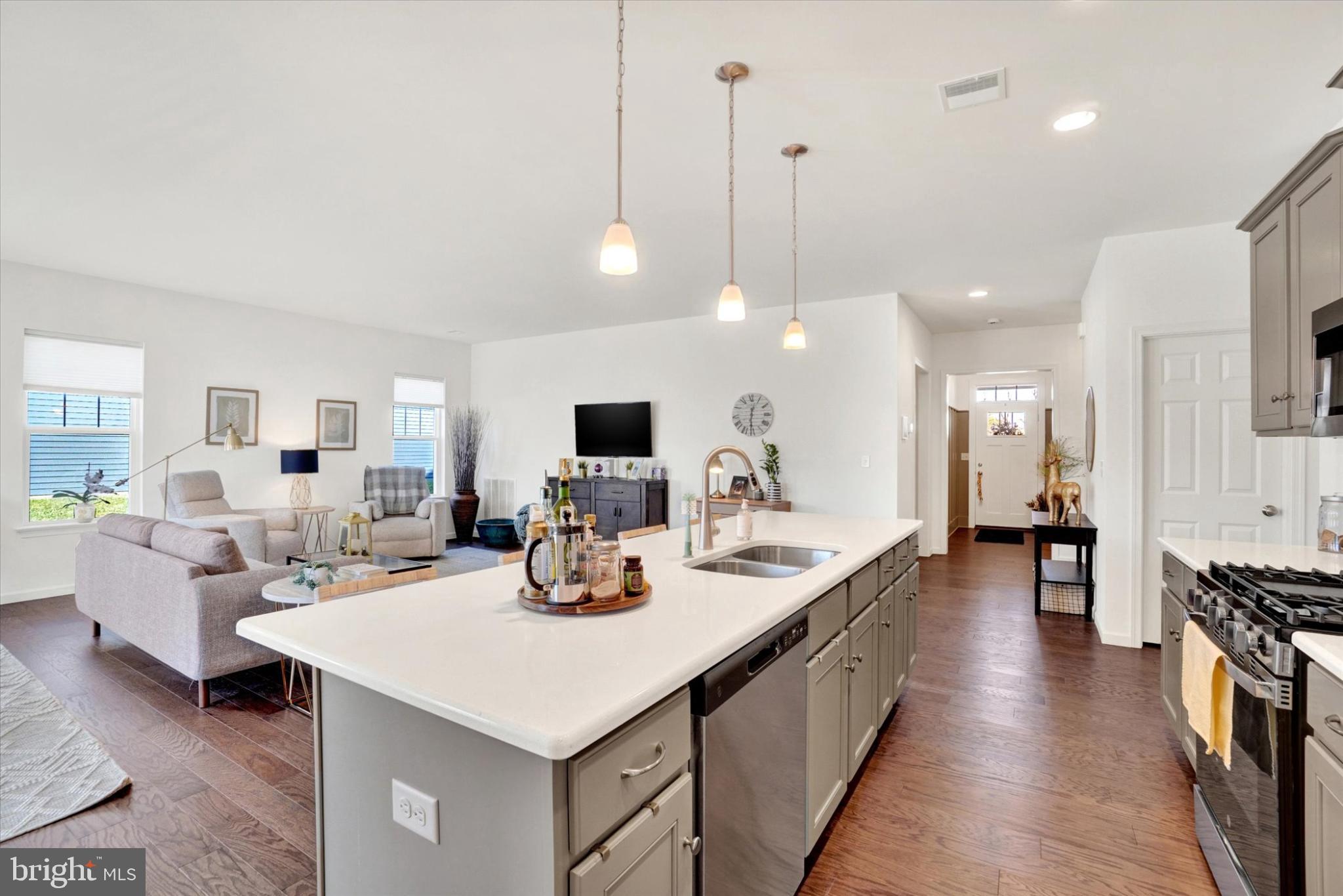 922 Shadowbrooke Dover, PA 17315 - Photo 6 of 25 a large kitchen with kitchen island a sink appliances and a living room view