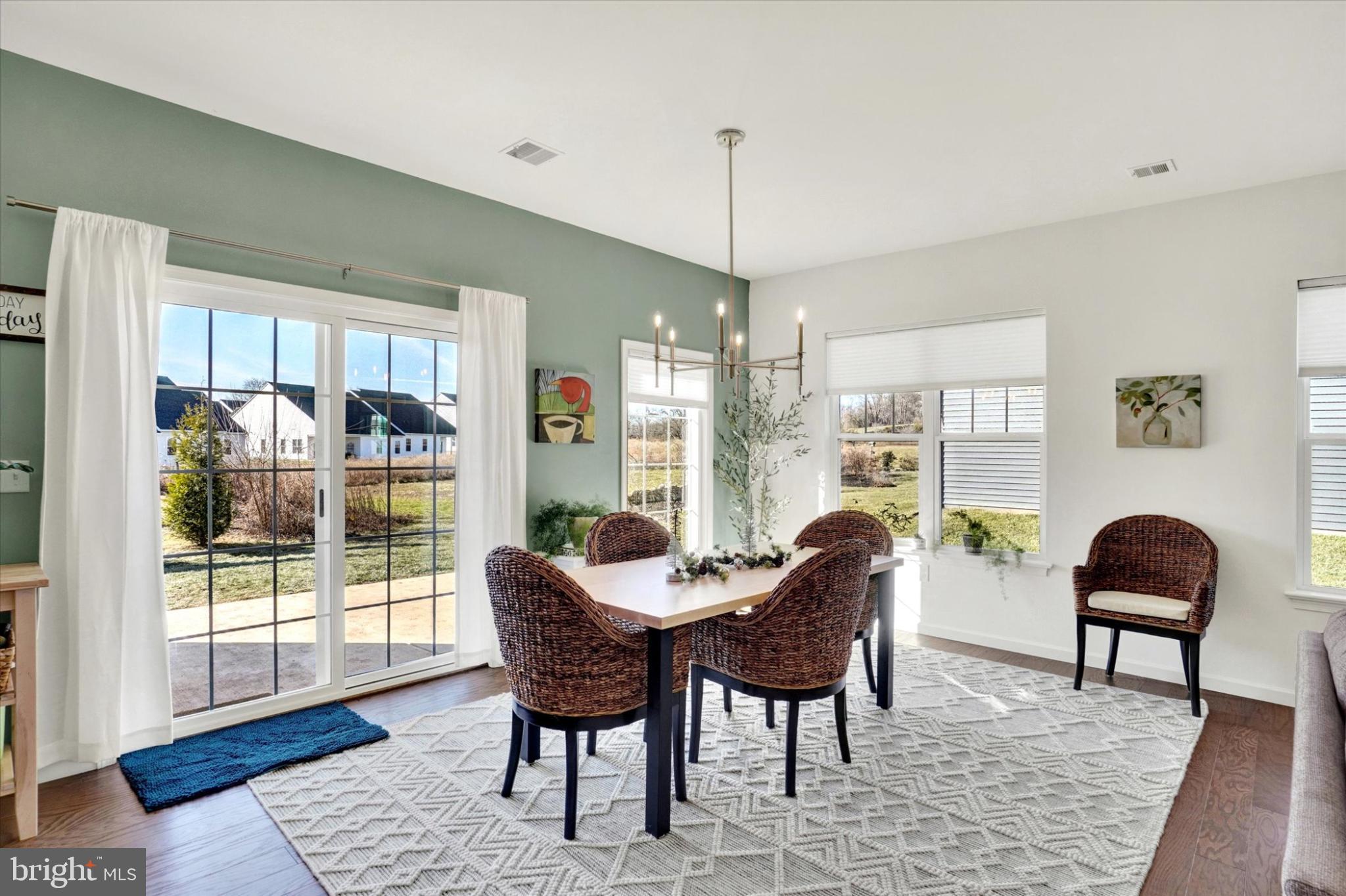 922 Shadowbrooke Dover, PA 17315 - Photo 9 of 25 a dining room with furniture a rug and a floor to ceiling window