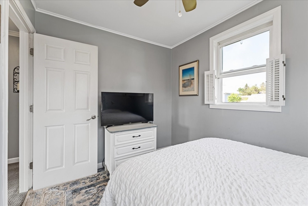 45 Tupelo Road South Kingstown, RI 02879 - Photo 14 of 28 a bedroom with a bed and a flat screen tv