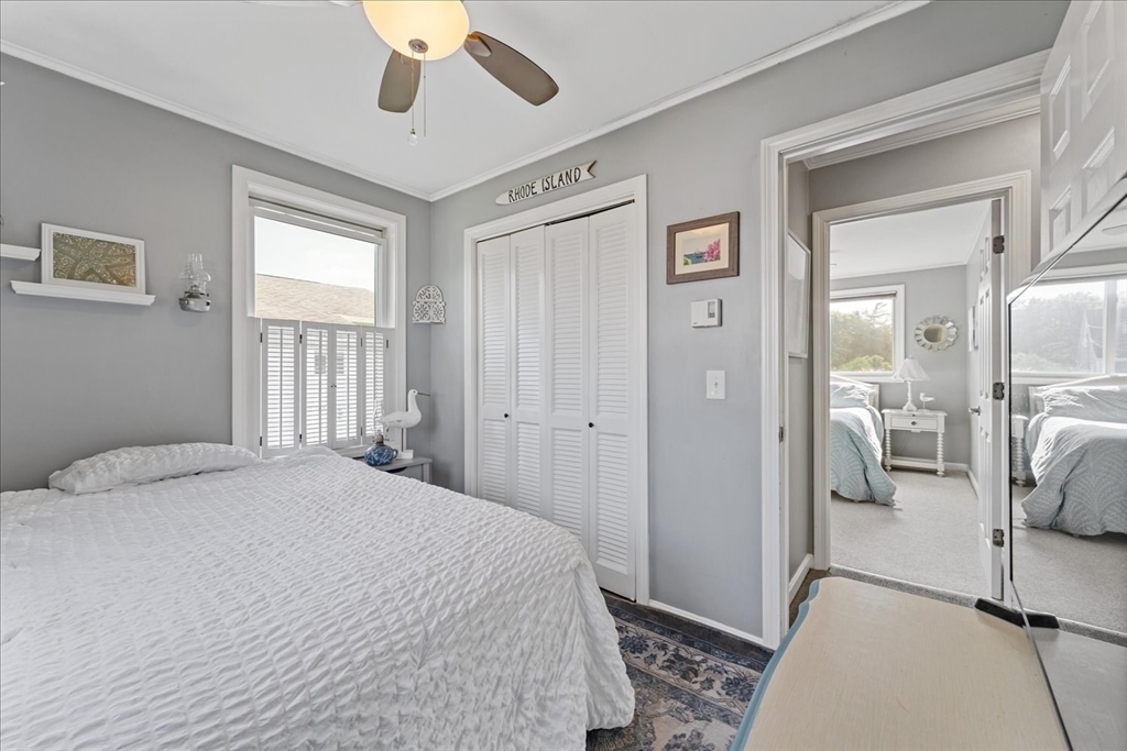 45 Tupelo Road South Kingstown, RI 02879 - Photo 15 of 28 a bedroom with a bed and a chandelier