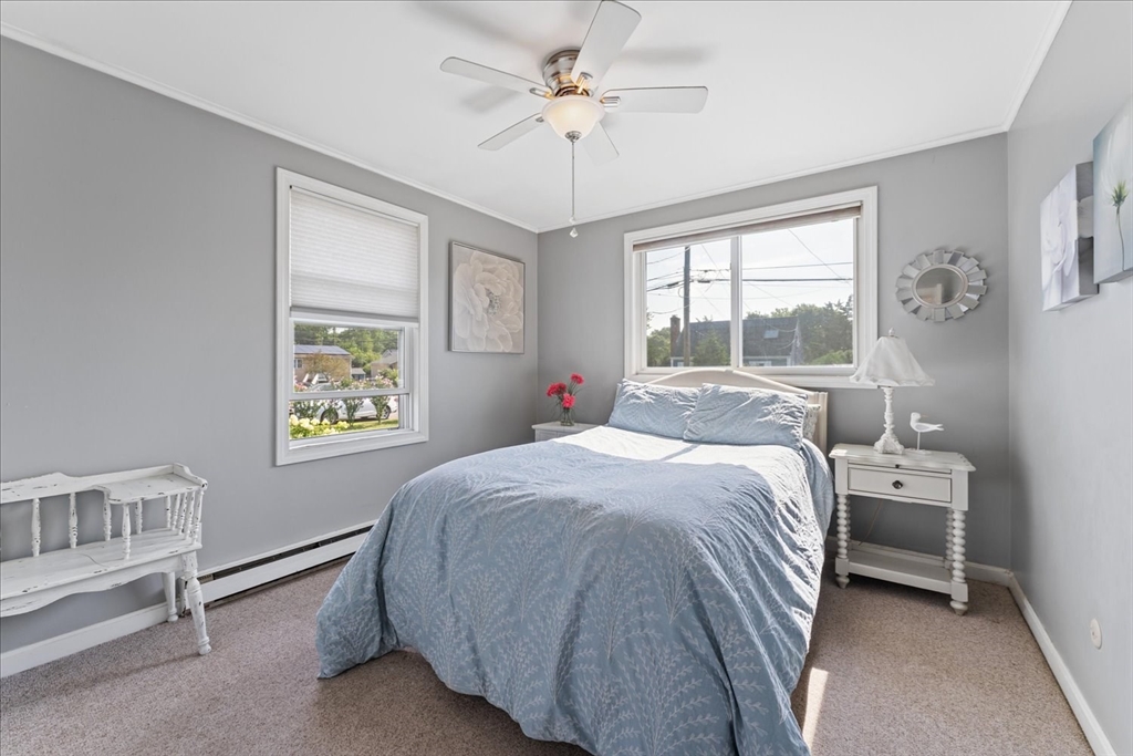 45 Tupelo Road South Kingstown, RI 02879 - Photo 10 of 28 a bed room with a bed and a chandelier