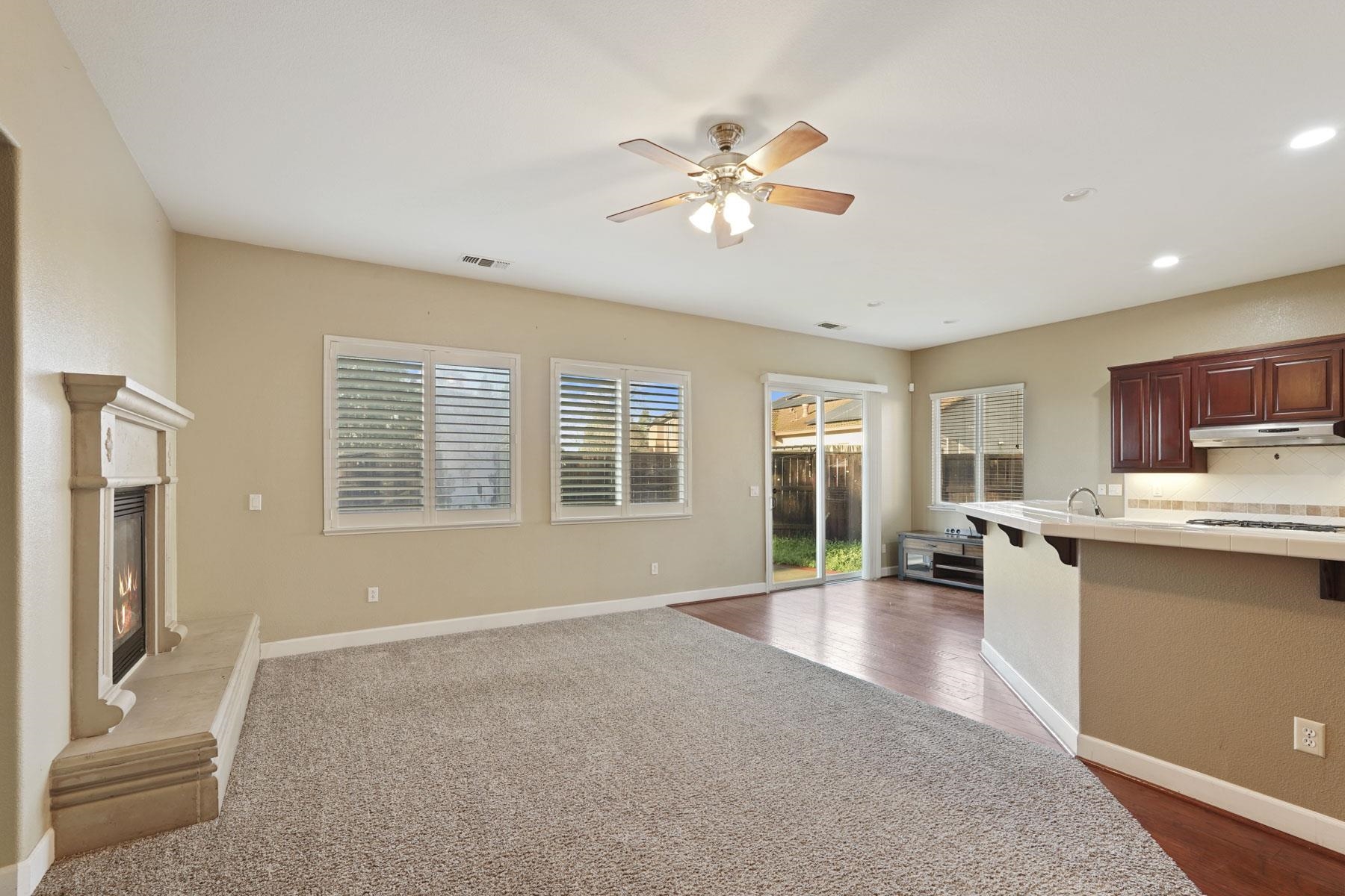 2644 Swainsons Hawk Street Stockton, CA 95209 - Photo 15 of 41 a living room with stainless steel appliances kitchen island furniture and windows