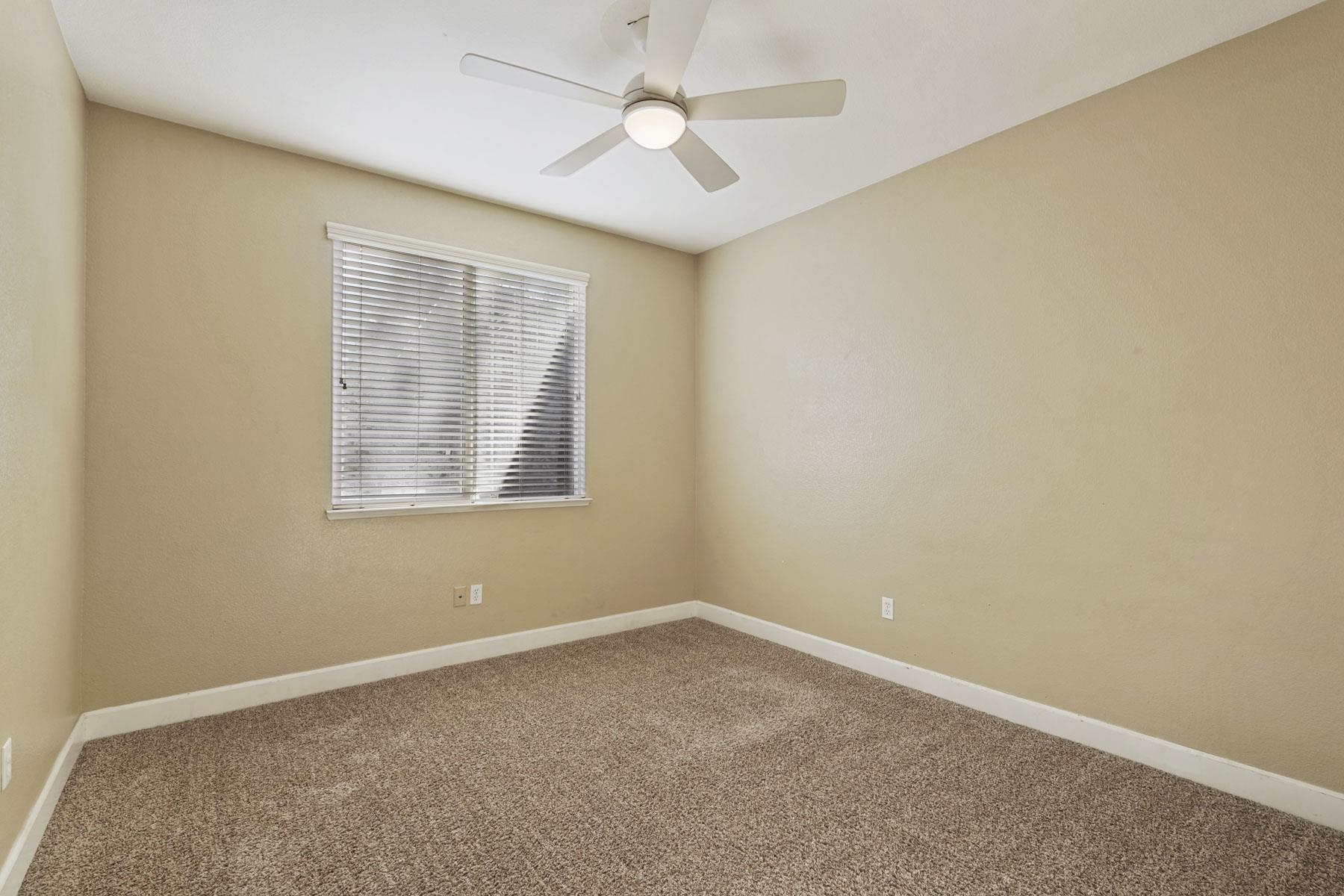 2644 Swainsons Hawk Street Stockton, CA 95209 - Photo 24 of 41 an empty room with a window and a fan
