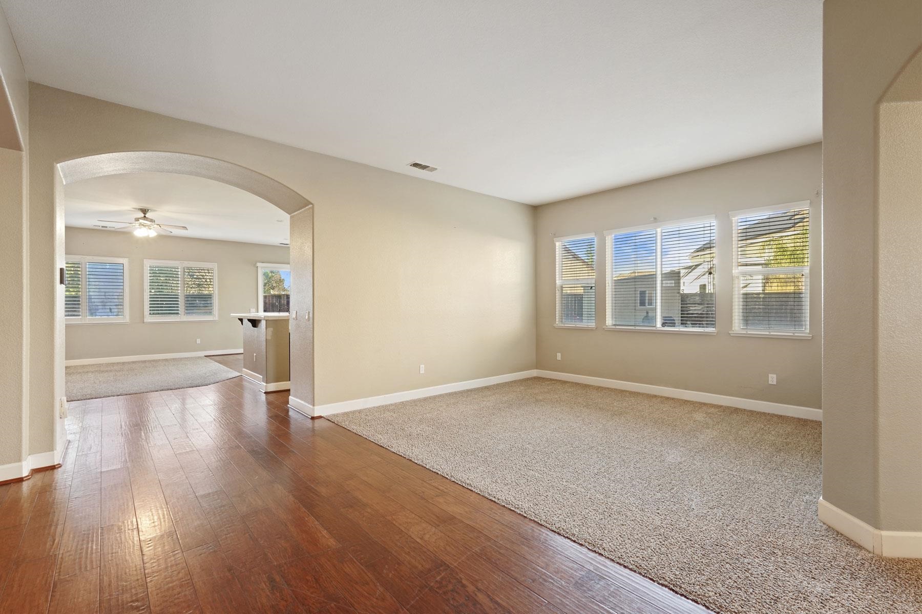 2644 Swainsons Hawk Street Stockton, CA 95209 - Photo 3 of 41 a view of an empty room with wooden floor and a window