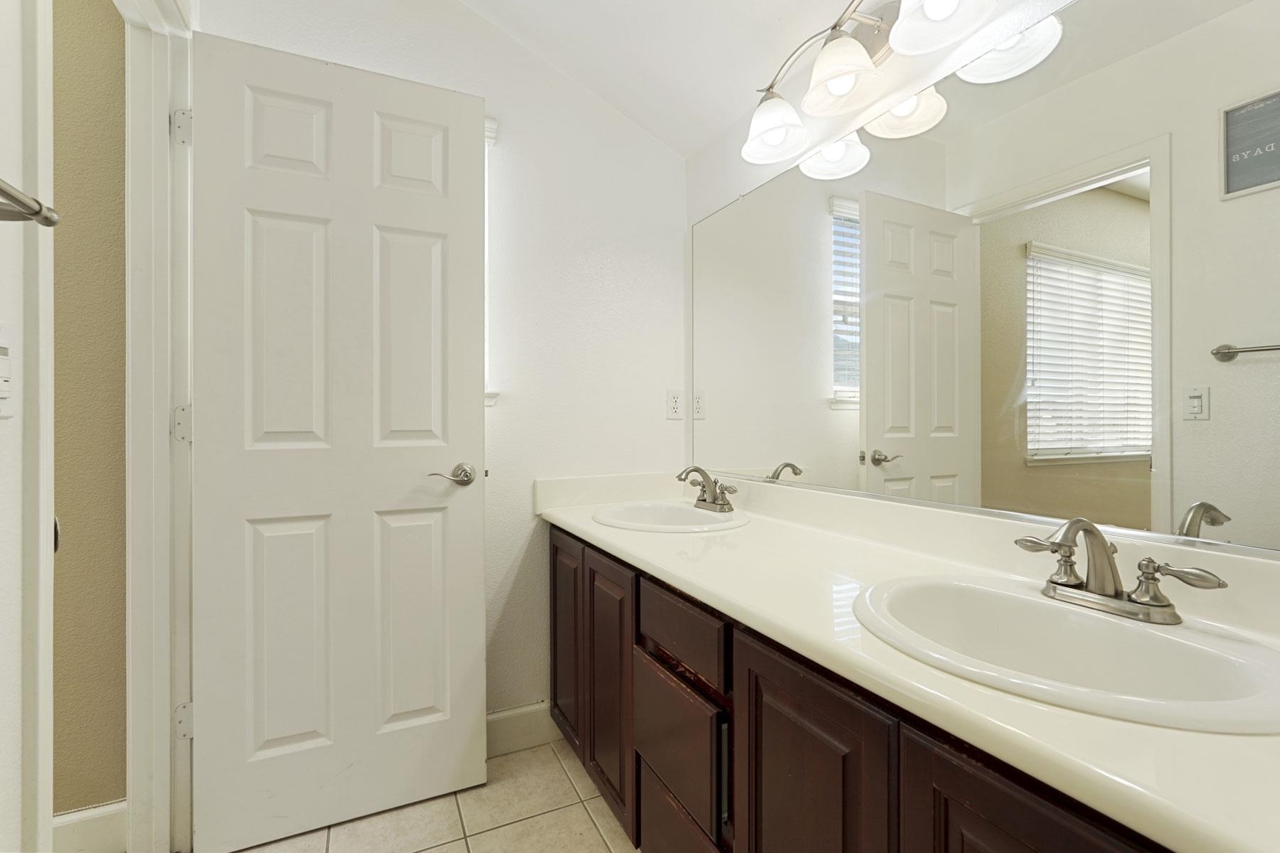 2644 Swainsons Hawk Street Stockton, CA 95209 - Photo 32 of 41 a bathroom with 2 sink and a mirror