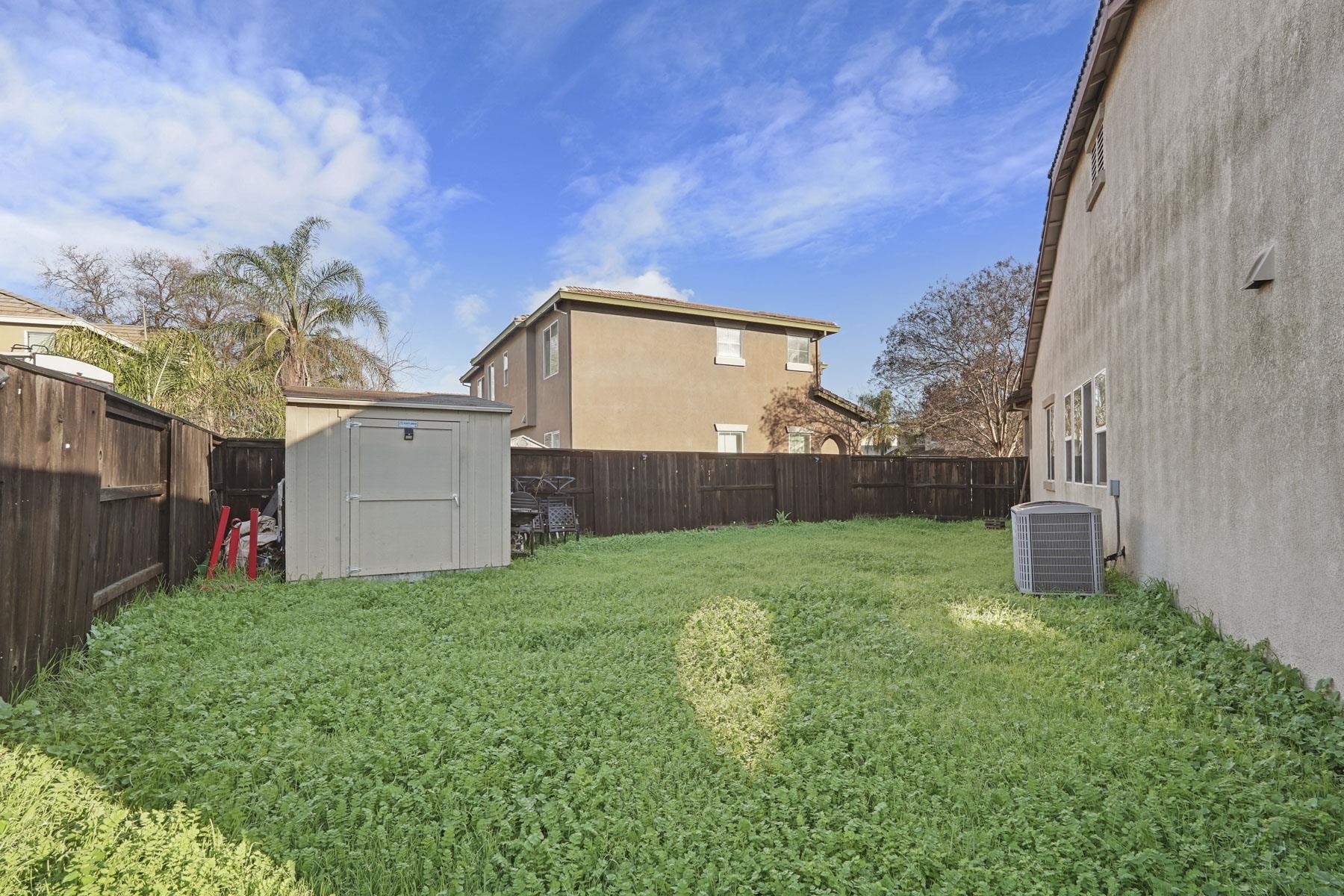 2644 Swainsons Hawk Street Stockton, CA 95209 - Photo 40 of 41 a view of a house with a yard and garage