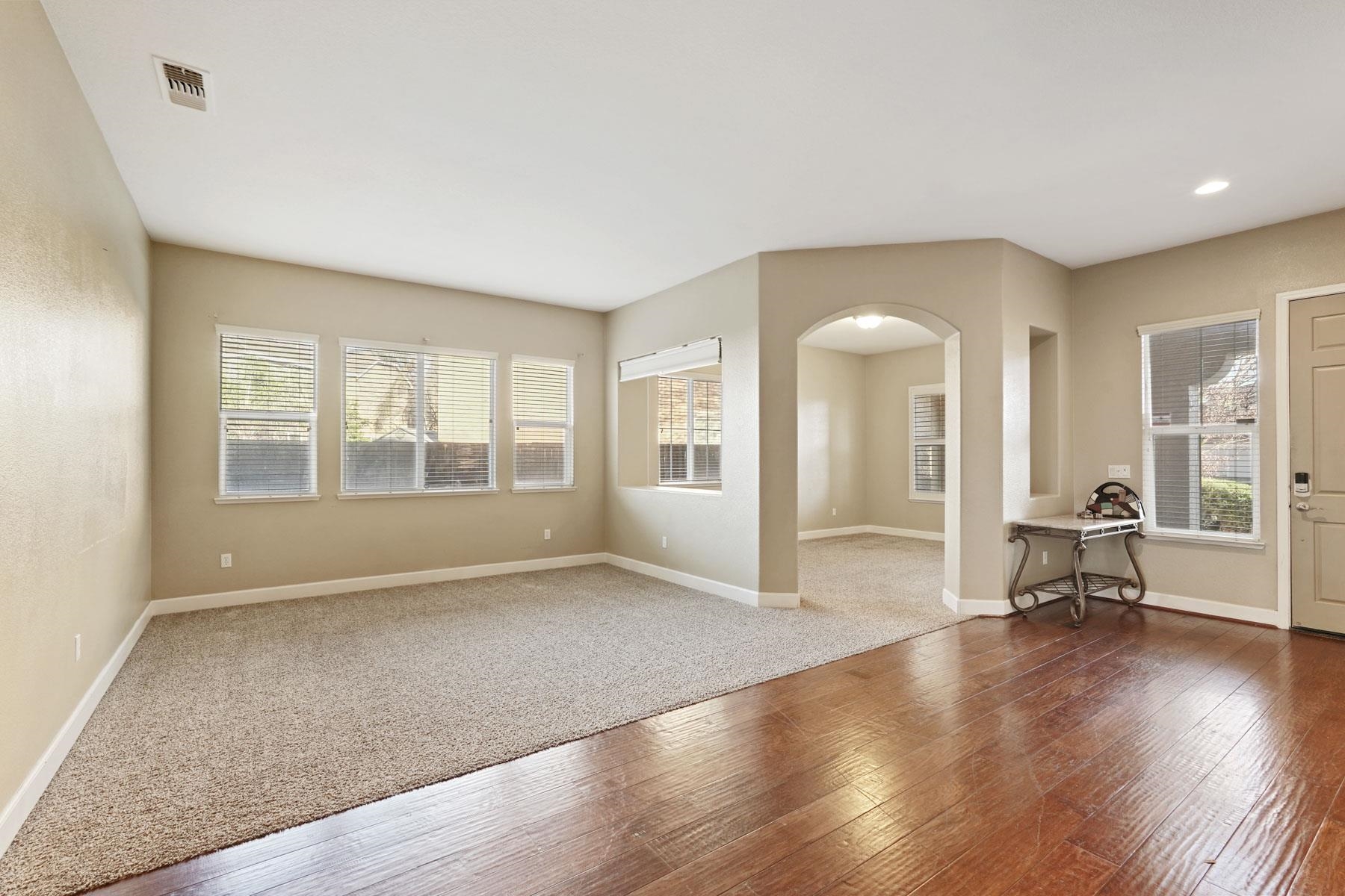 2644 Swainsons Hawk Street Stockton, CA 95209 - Photo 4 of 41 a view of an empty room with glass door and wooden floor