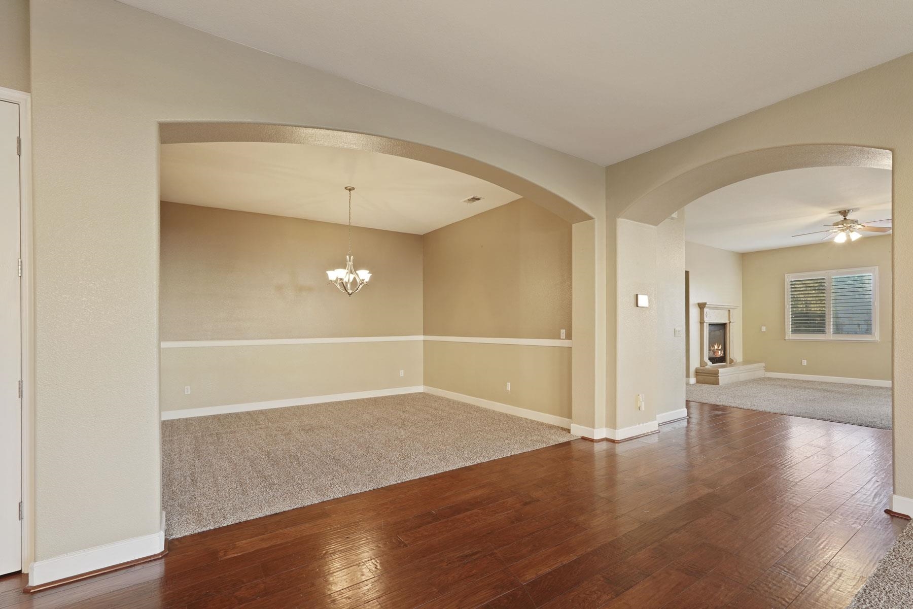 2644 Swainsons Hawk Street Stockton, CA 95209 - Photo 5 of 41 an empty room with wooden floor and windows