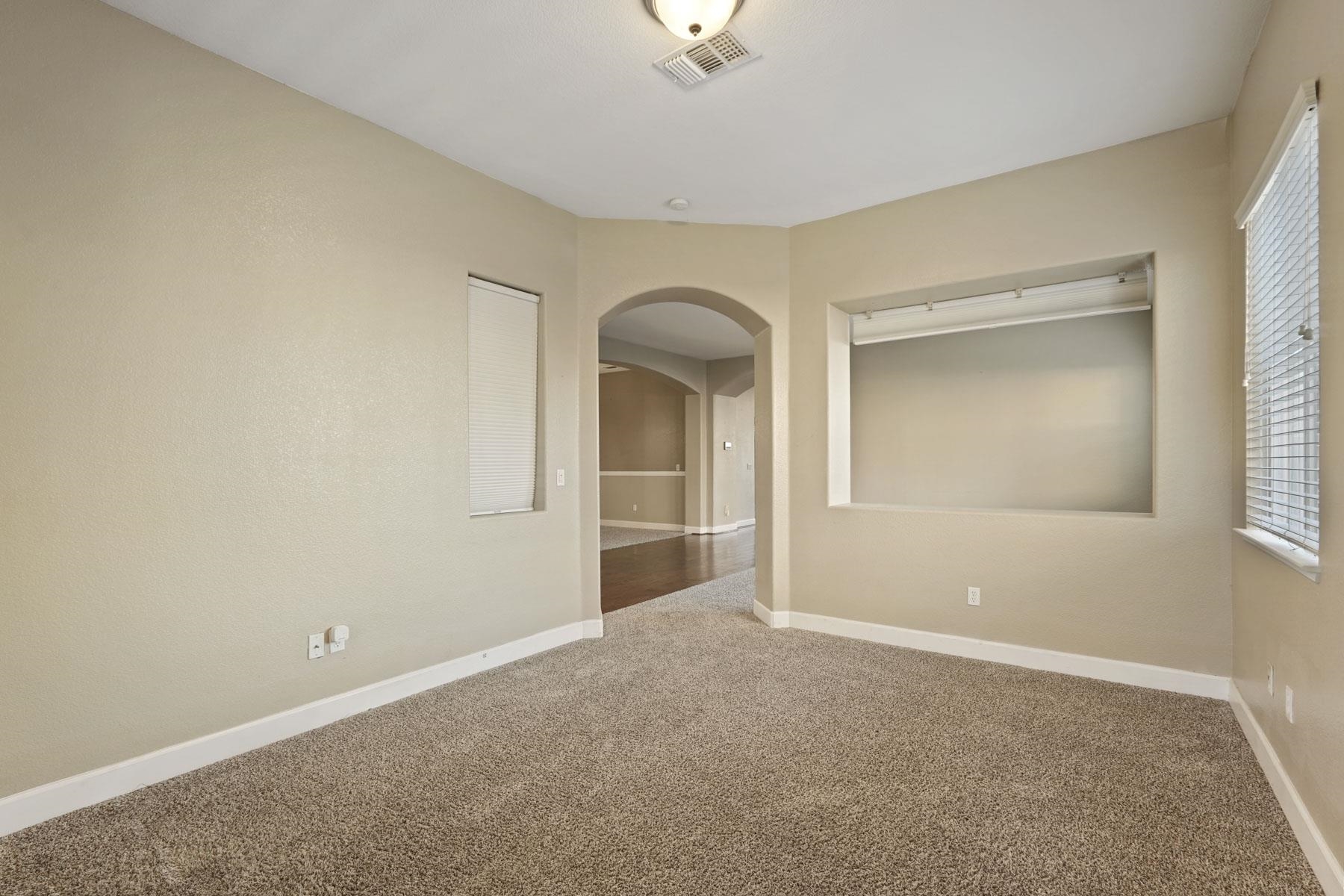 2644 Swainsons Hawk Street Stockton, CA 95209 - Photo 8 of 41 a view of an empty room with window and wooden floor