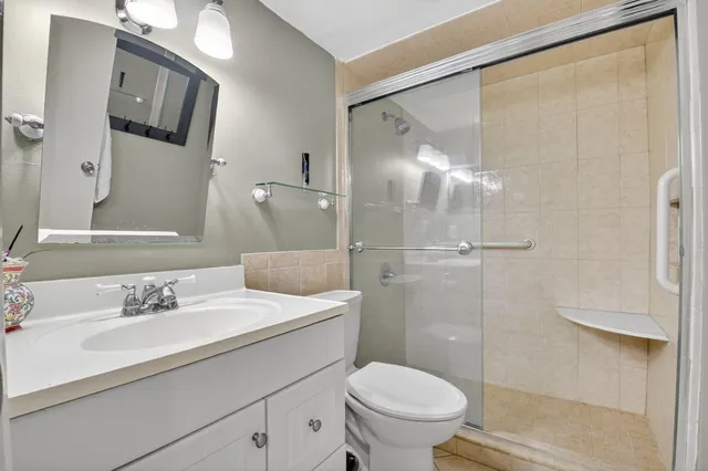 a bathroom with a sink toilet and shower