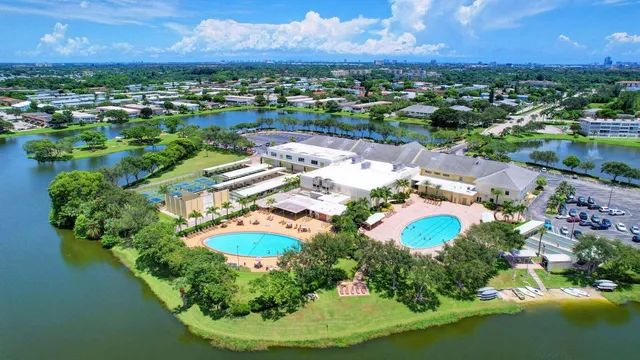 an aerial view of residential houses with outdoor space and lake view