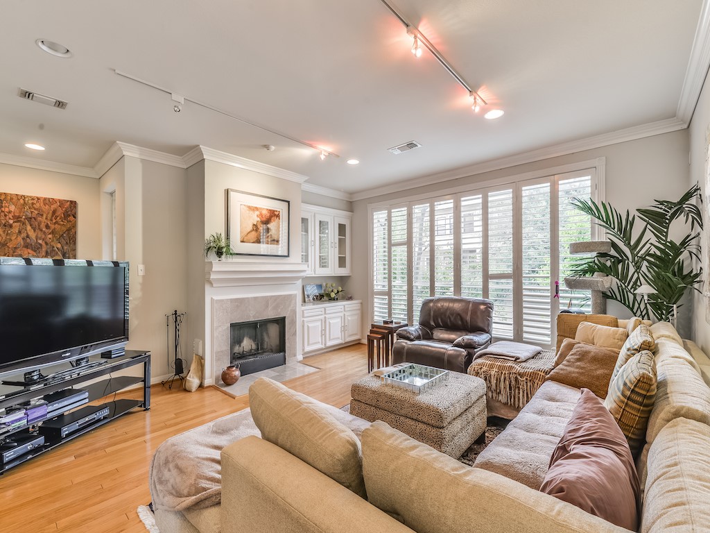 6409 Prague Street Houston, TX 77007 - Photo 2 of 11 The living room is on the second floor and looks out through the trees.