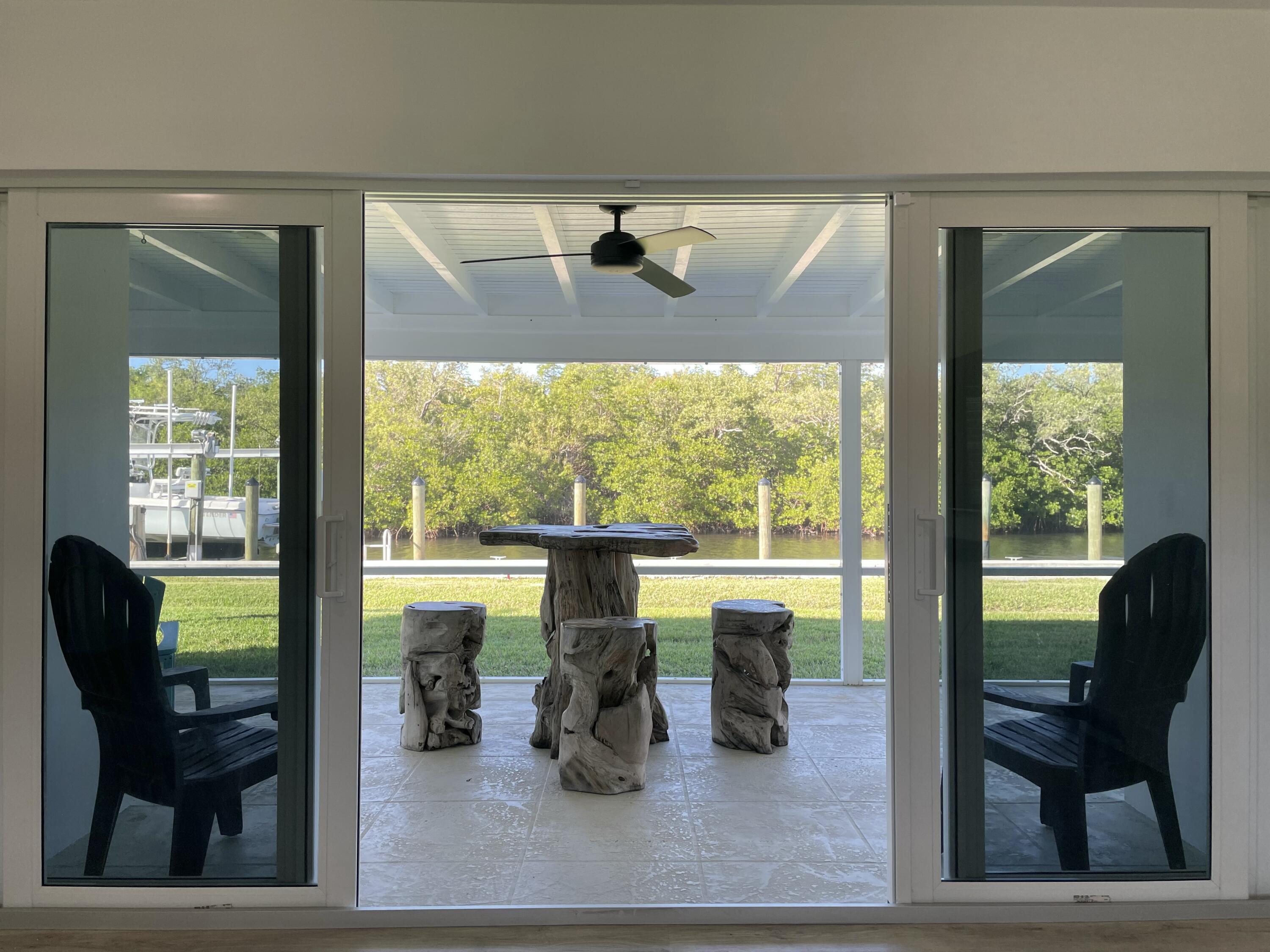 8585 Southeast Palm Street Hobe Sound, FL 33455 - Photo 25 of 43 Sliders to Screened Patio