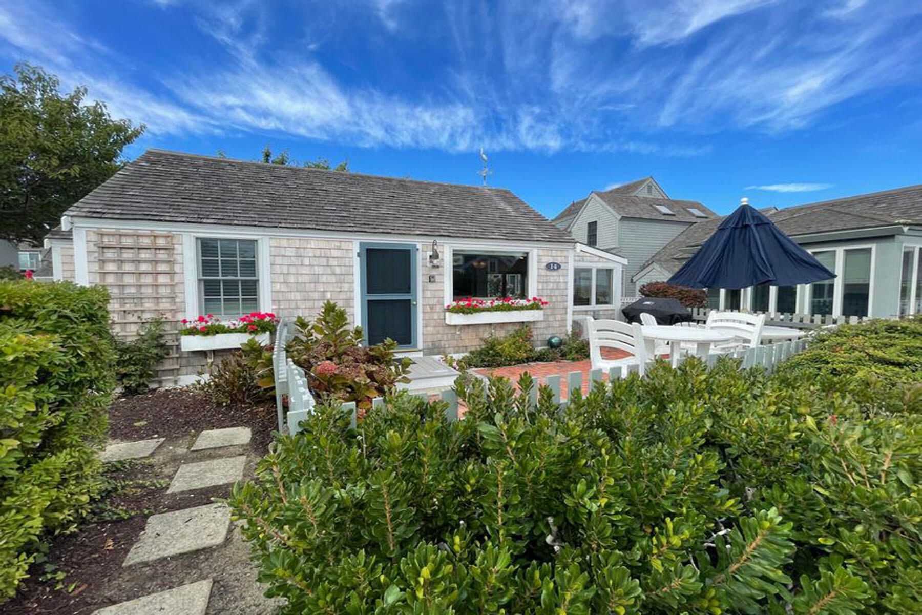 a front view of a house with garden
