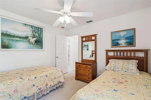 a bedroom with 2 bed and a chandelier