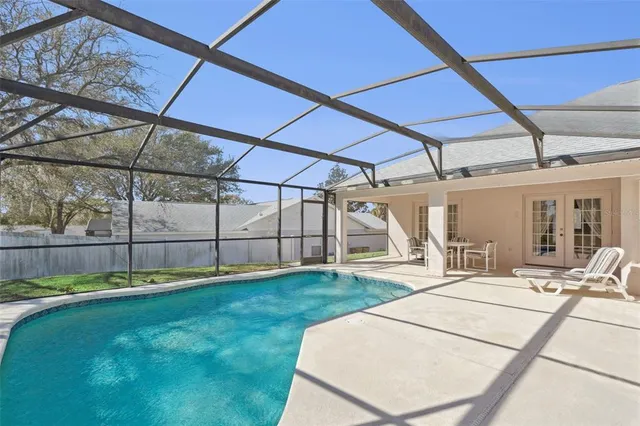 a view of a backyard with wooden fence